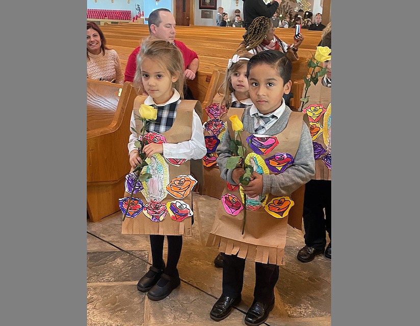Kindergarten students in St. Mary Academy, Manahawkin, begin a school prayer service by leading a procession with roses for the Our Lady of Guadalupe Dec. 12 wearing homemade tilmas to signify that of Juan Diego, to whom the Blessed Mother appeared. Courtesy photo