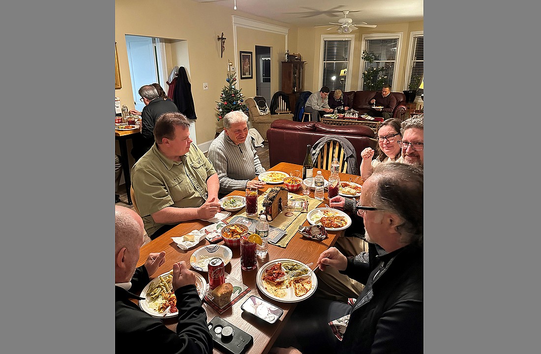 Diaconate candidates and their spouses enjoy a Christmas dinner hosted by Father Christopher Colavito in the Bede House, home of Catholic campus ministry for The College of New Jersey, Ewing. Courtesy photo