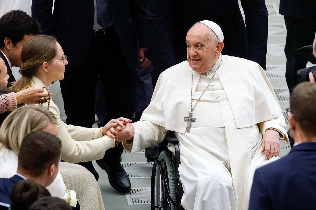 Pope Francis greets a newlywed couple at the end of his weekly general audience in the Paul VI Audience Hall at the Vatican Dec. 13, 2023. (CNS photo/Lola Gomez)