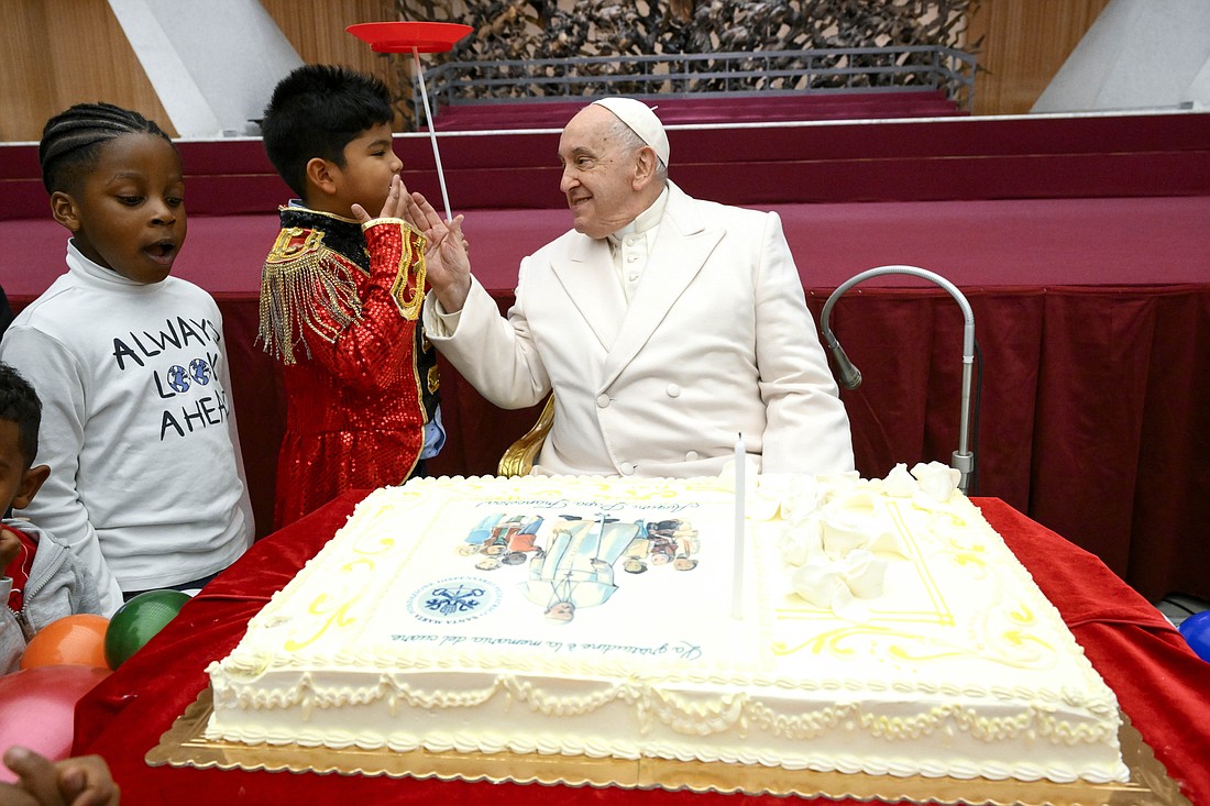 Pope Francis is joined on his 87th birthday by children assisted at the Vatican's pediatric clinic in the Paul VI Hall Dec. 17, 2023. (CNS photo/Vatican Media)