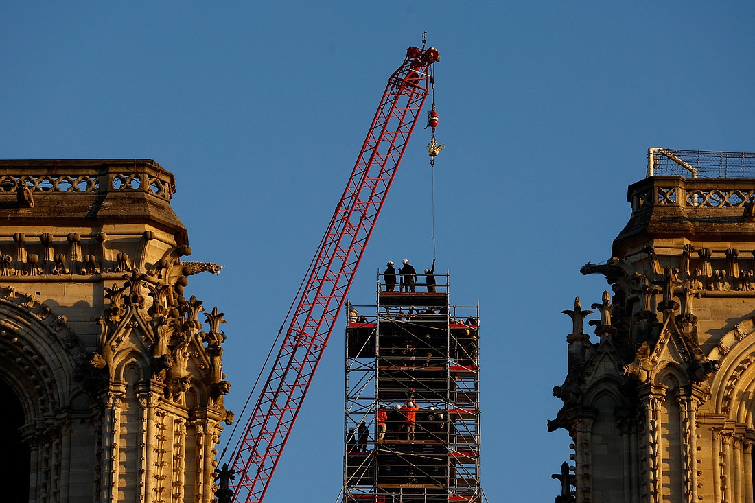 A crane raises the new golden rooster to install it at the top of the spire of the Notre Dame Cathedral in Paris Dec.16, 2023. The rooster symbolizes resilience amid destruction after the devastating April 2019 fire -- as restoration officials also revealed an anti-fire misting system is being kitted out under the cathedral's roof. (OSV News photo/Christian Hartmann, Reuters)