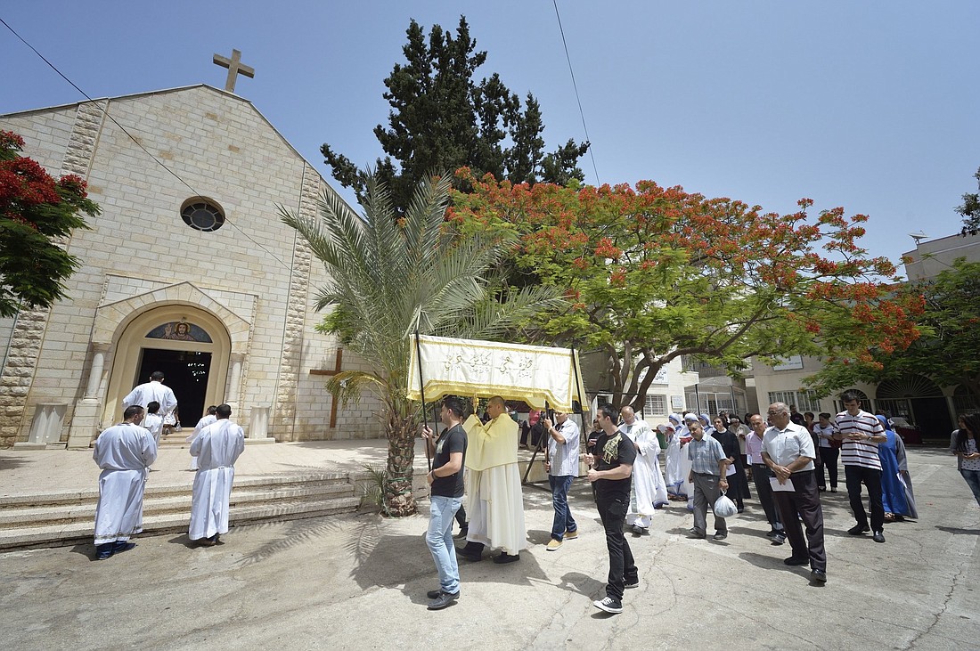 A clergyman is pictured in a file photo carrying the monstrance during a Eucharistic procession outside Holy Family Catholic Church in the Gaza Strip. Following a series of attacks on Christians in Gaza by Israeli forces Dec. 16, 2023, including the killing of a mother and daughter at the parish, the Israeli Defense Forces denied claims that it targeted civilians in the Catholic parish. (OSV News photo/Paul Jeffrey)