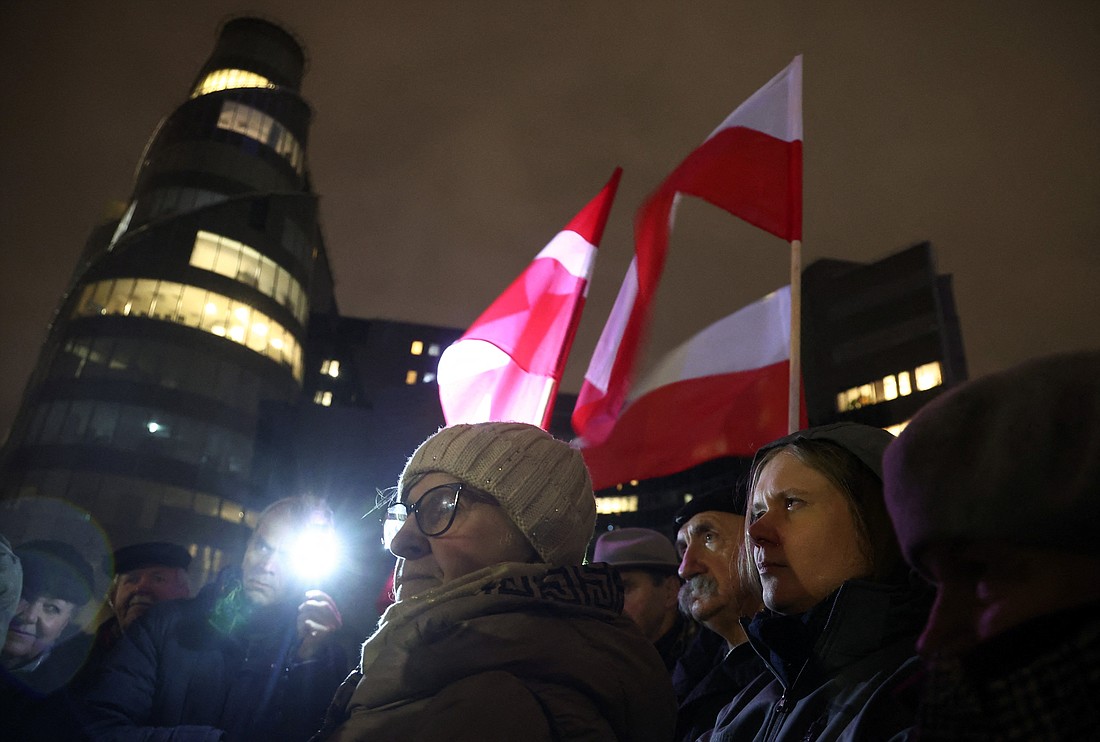 People stand outside the Polish public television TVP building as protesters and Law and Justice politicians gather after Poland's new government took a public news channel off the air and dismissed executives from state media to restore "impartiality," the culture ministry said, in Warsaw, Poland, Dec. 20, 2023. (OSV News photo/Kacper Pempel, Reuters)