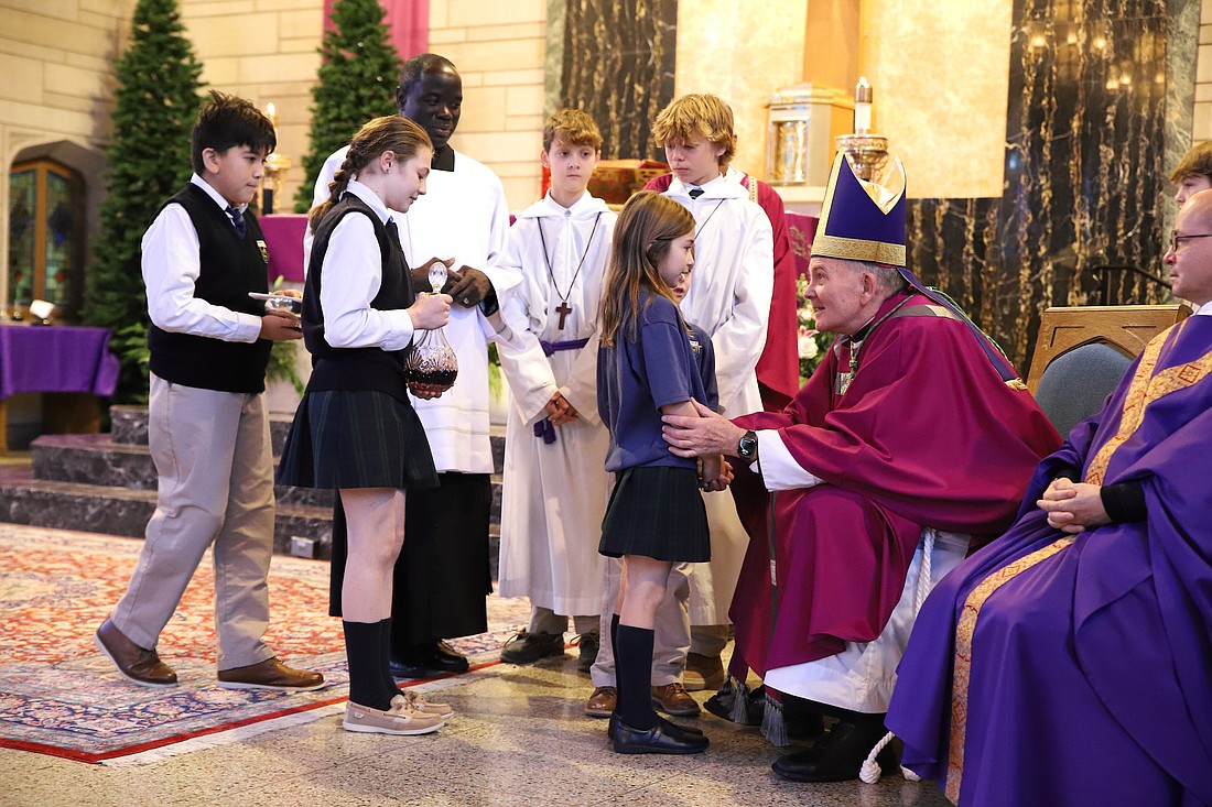 Students present the gifts during the Offertory Procession. John Batkowski photo