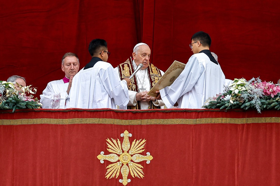 Pope Francis prays before giving his Christmas blessing "urbi et orbi" (to the city and the world) from the central balcony of St. Peter's Basilica at the Vatican Dec. 25, 2023. CNS photo/Lola Gomez