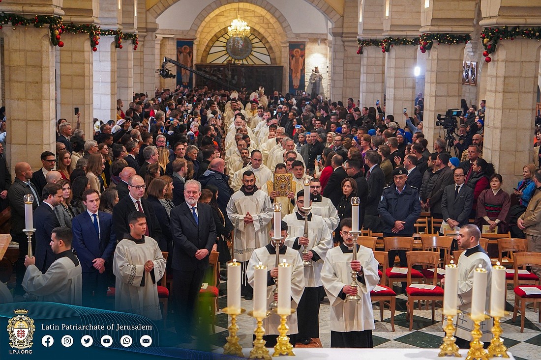 Latin Patriarch of Jerusalem Cardinal Pierbattista Pizzaballa and Cardinal Konrad Krajewski, prefect of Vatican Dicastery for the Service of Charity, participate in a procession at the beginning of Mass at the Church of the Nativity in Bethlehem, on the West Bank, Dec. 24, 2023. Cardinal Krajewski arrived in the Holy Land Dec. 22 to be present to Palestinian Christians during Christmas amid the ongoing Israel-Hamas war. (OSV News photo/courtesy Latin Patriarchate of Jerusalem)