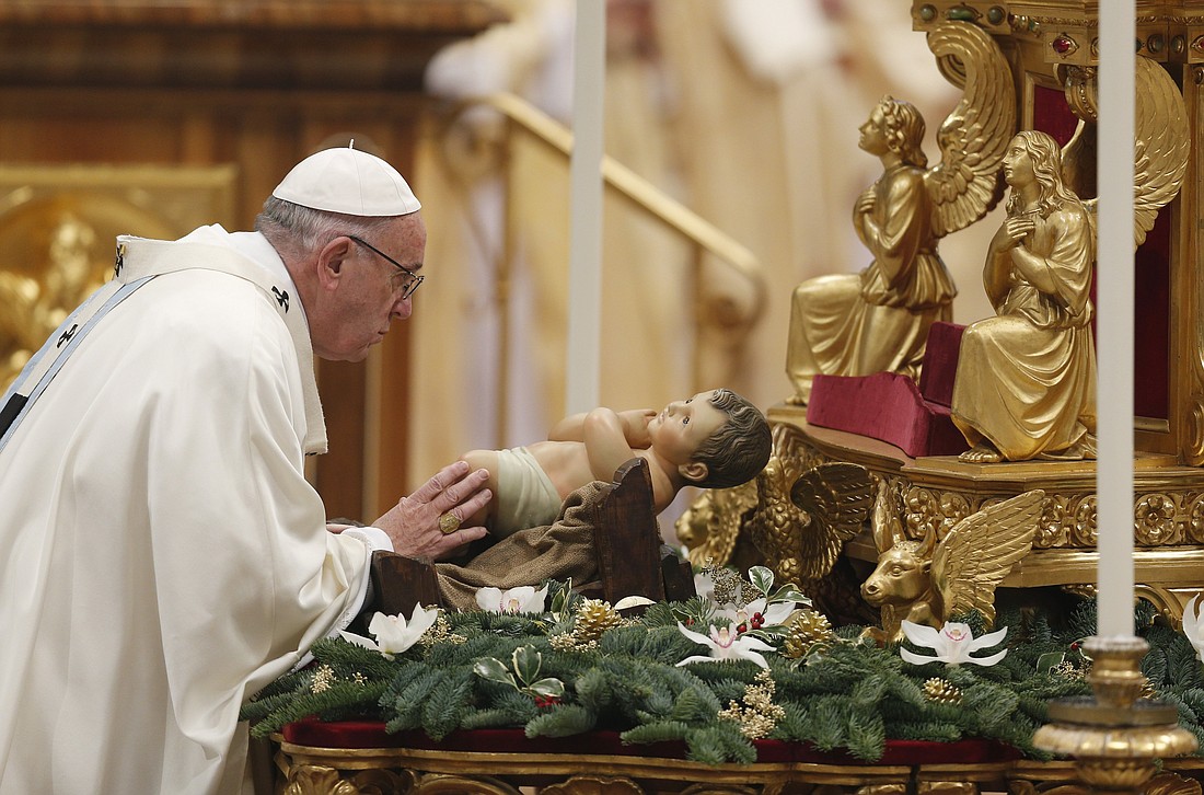 Pope Francis venerates a figurine of the baby Jesus at the start of a Mass marking the feast of Mary, Mother of God, in St. Peter's Basilica at the Vatican Jan. 1, 2017. (CNS photo/Paul Haring) S