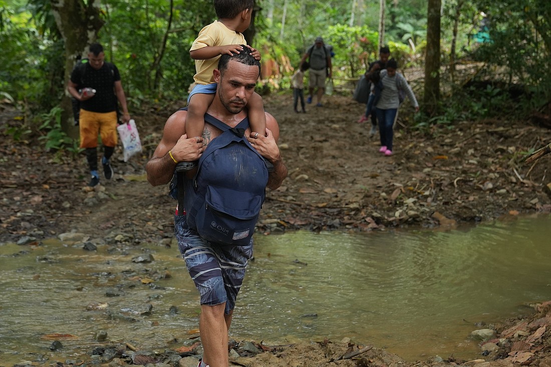 A migrant and his child begin the trek through the Darién Gap in Colombia April 30, 2023. The trek across the roadless jungle takes two to three days. According to UNICEF, more than 32,500 children have walked through Panama’s jungle in 2022. Half of them were younger than 5 years old. (OSV News photo/Manuel Rueda, Global Sisters Report)