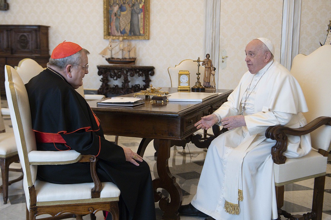 Pope Francis and U.S. Cardinal Raymond L. Burke meet in the library of the Apostolic Palace at the Vatican Dec. 29, 2023. (CNS photo/Vatican Media)