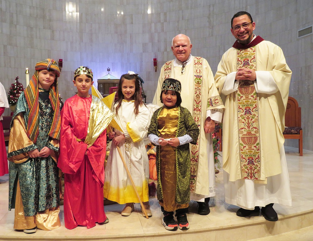 Young people from St. Anthony of Padua Parish, Hightstown, dress as the Three Kings for Mass on Epiphany Sunday, Jan. 7. Also pictured are Deacon Tom Garvey and Father Arian Wharff, parochial vicar. Courtesy photo