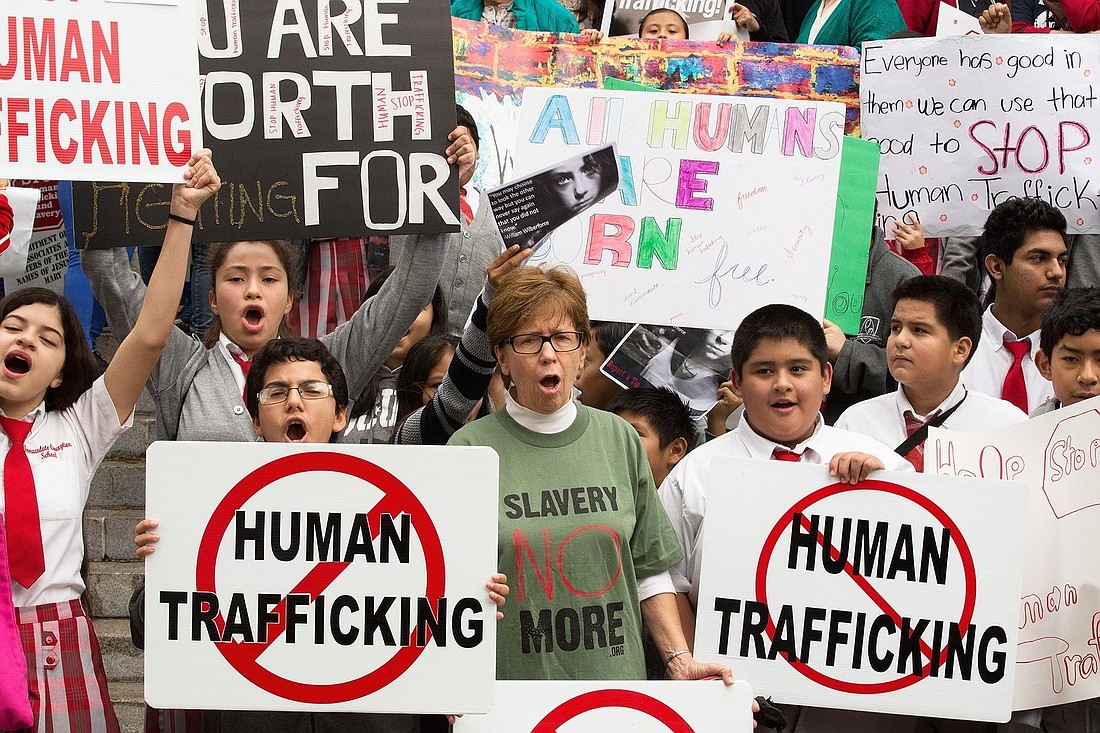 People are pictured in a file photo displaying signs in Los Angeles during the "Walk 4 Freedom" in advance of the Jan. 11 National Human Trafficking Awareness Day. January is Human Trafficking Awareness month in the U.S. (OSV News photo/CNS file, Victor Aleman, Vida Nueva)