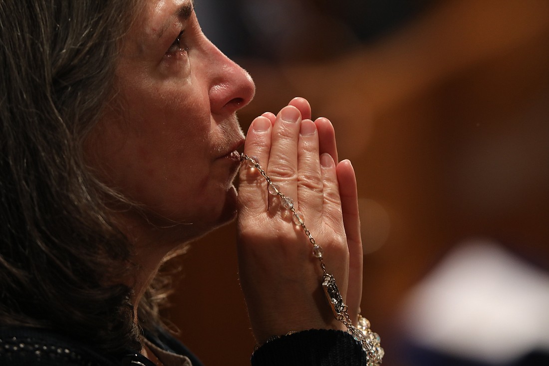 A woman becomes emotional as she prays with a rosary during Eucharistic adoration following the opening Mass of the National Prayer Vigil for Life Jan. 19, 2023, at the Basilica of the National Shrine of the Immaculate Conception in Washington. From Jan. 16-24, 2024, the U.S. bishops' Committee on Pro-Life Activities is inviting Catholics nationwide to pray "9 Days for Life." The annual Respect Life novena encompasses observance of the annual Day of Prayer for the Legal Protection of Unborn Children, which is Jan. 22. (OSV News photo/Bob Roller)