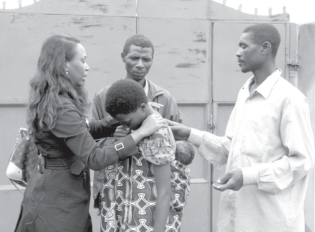 Immaculee Ilibagiza, left, encourages a woman whose family was killed in the 1994 Rwandan genocide to reconcile with her neighbors, also pictured in this 2011 photo, who were believed to have participated in some of the murders. Patrick Dolan file photo