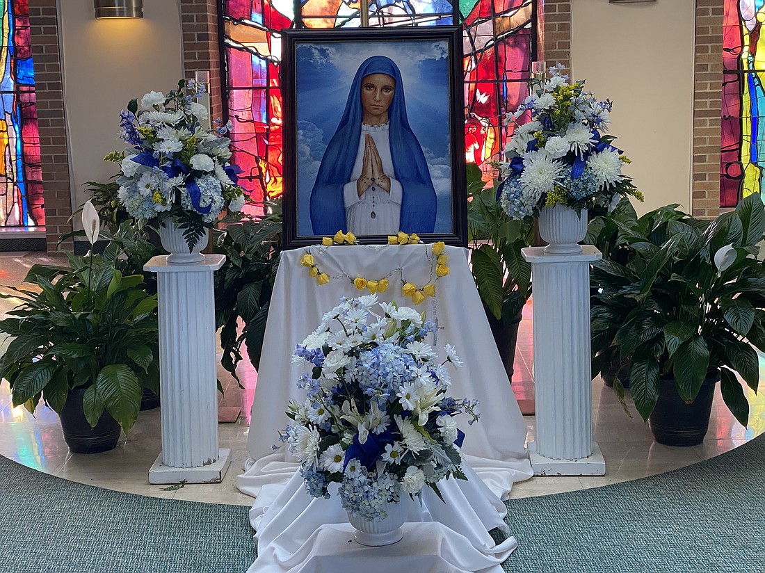 An artist’s rendition of the Church-approved image of Our Lady of Kibeho was blessed by Father Scott Shaffer during the Nov. 3 Mass in St. Joseph Church. Courtesy photo