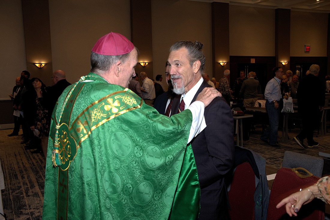 Bishop David M. O’Connell, C.M., greets Ford during the 2022 Rite of Candidacy for men who were admitted to pursue formation in the diocesan diaconate program. Joe Moore photo