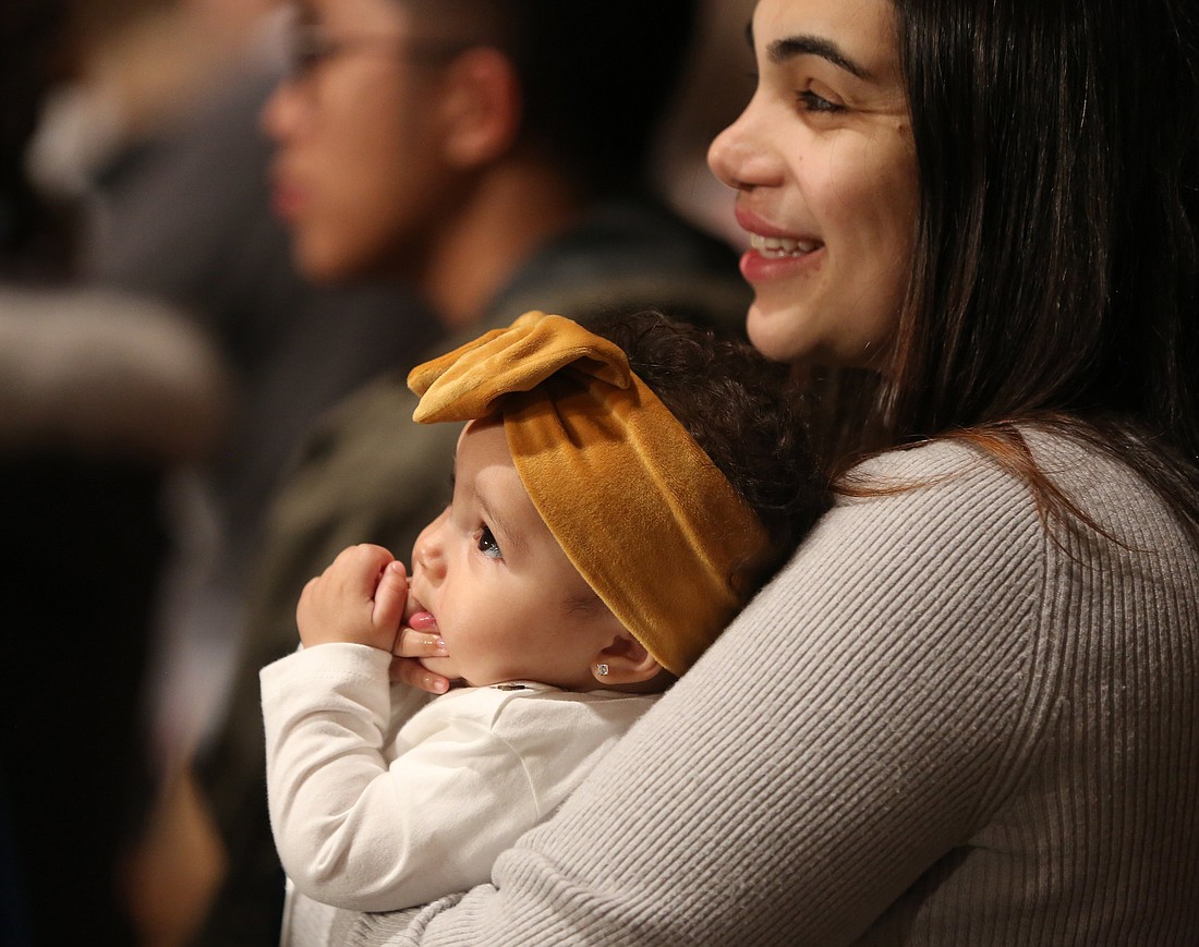 A woman holds her daughter during the opening Mass of the National Prayer Vigil for Life Jan. 19, 2023, at the Basilica of the National Shrine of the Immaculate Conception in Washington. (OSV News photo/Bob Roller)