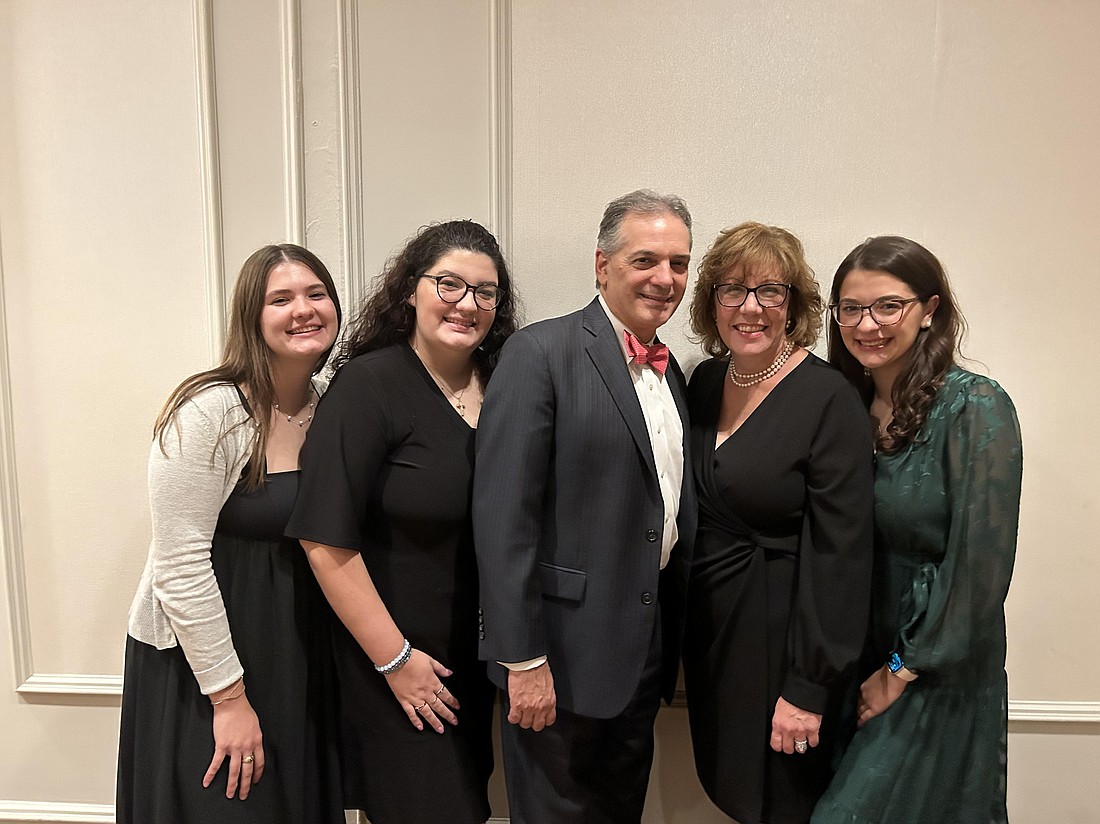 Laura Sarubbi pauses at the Mount Carmel Guild Gala Oct. 20, 2023, for a photo with her husband and daughters, from left: Anna, Kate, Joe, Laura and Teresa. Joe and Laura were honored at the Gala with the Guild Appreciation Award. Courtesy photo