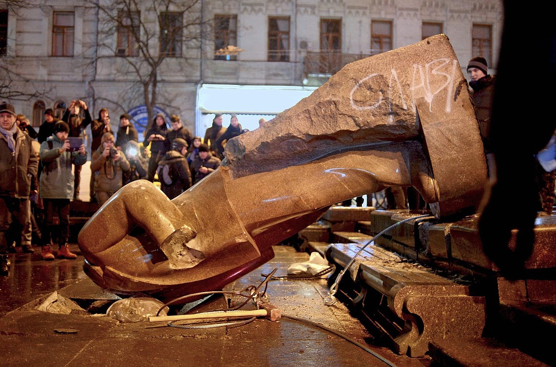 A 2013 file photo shows people surrounding a statue of Soviet state founder Vladimir Lenin, which was toppled by protesters during a rally organized by the European Union integration in Independence Square in central Kiev, Ukraine. The 100th anniversary of Lenin's death is Jan. 21, 2024. (OSV News photo/Maks Levin, Reuters)