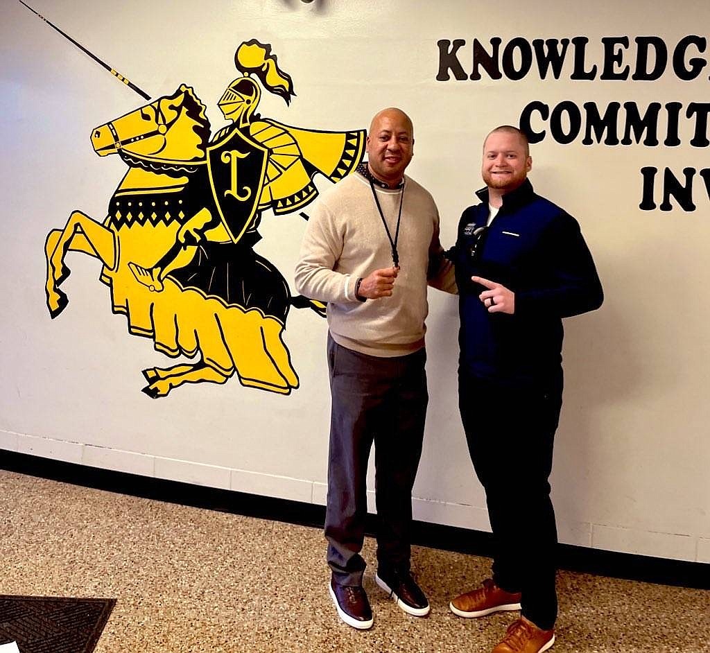 New St. John Vianney football coach Bobby Acosta (left) shares a smile with former Lancers football coach/athletic director Mike Alberque after Acosta's hiring on Jan. 15. Courtesy photo