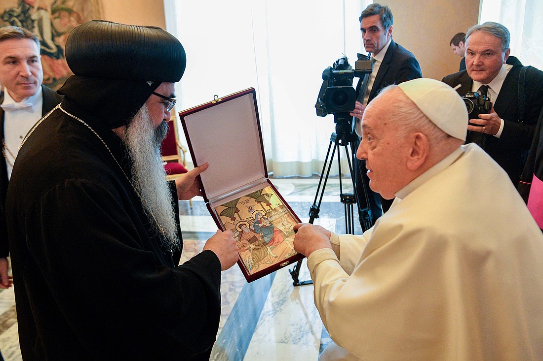 Coptic Orthodox Bishop Kyrillos of Los Angeles presents a gift to Pope Francis Jan. 26, 2024, during a meeting with members of the International Joint Commission for Theological Dialogue between the Catholic Church and the Oriental Orthodox Churches at the Vatican. (CNS photo/Vatican Media)
