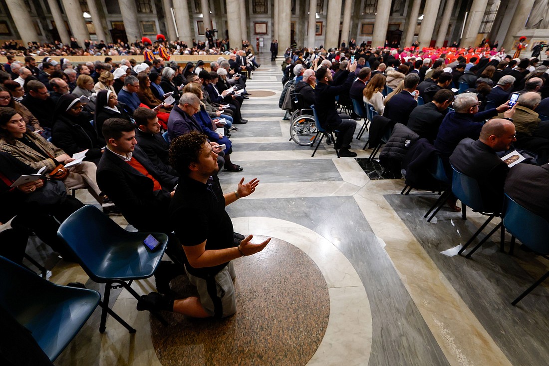 A man kneels to pray during an evening prayer service presided over by Pope Francis at the Basilica of St. Paul Outside the Walls in Rome Jan. 25, 2024. The service marked the end of the Week of Prayer for Christian Unity.