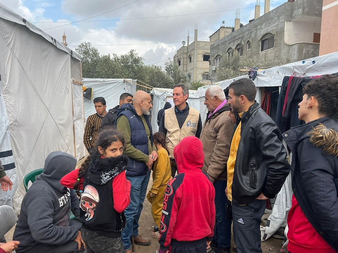 Sean Callahan, president of Caritas North America and CEO of Catholic Relief Services, in a tan vest, is pictured at a camp for displaced people during his visit to southern Gaza Jan. 23, 2024. (OSV News photo/courtesy Catholic Relief Services)