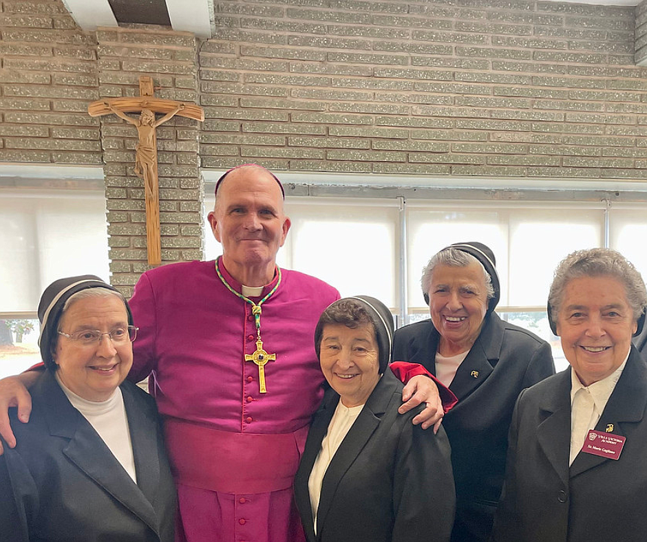 Bishop David M. O'Connell, C.M., visits with some of the Religious Teachers Filippini during the reception that followed the Mass celebrating the 90th anniversary of the all-girls school in Ewing. Rose O’Connor photo.