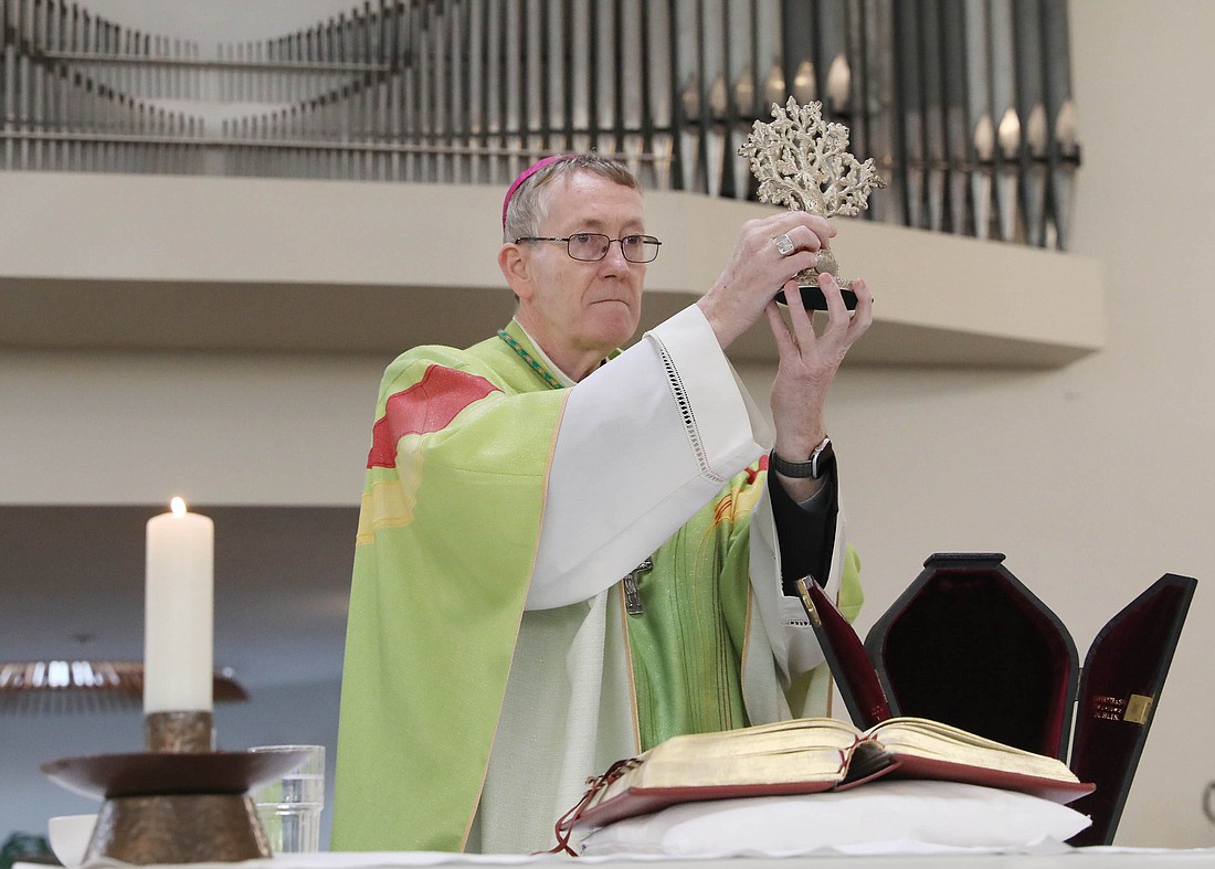 Irish Bishop Denis Nulty of Kildare and Leighlin raises the St. Brigid relic after removing it from it’s box at the beginning of Mass at St. Brigid's Church in Kildare Jan. 28, 2024. (OSV News photo/John Mc Elroy)