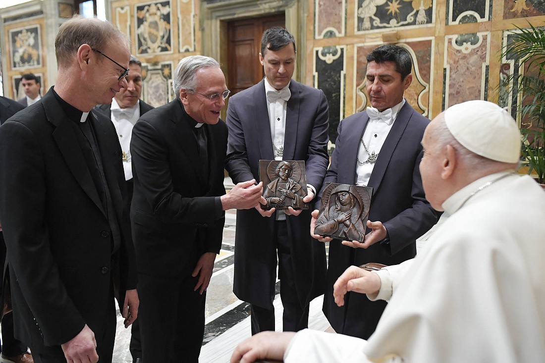 Pope Francis receives gifts from Holy Cross Father John I. Jenkins, president of the University of Notre Dame, center, and Holy Cross Father Robert A. Dowd, president-elect, left, during a meeting with the university's board of trustees at the Vatican Feb. 1, 2024. (CNS photo/Vatican Media)