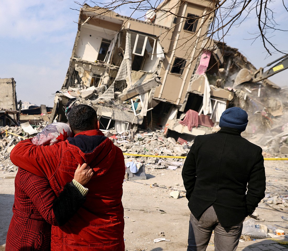 A wife and husband embrace outside of their destroyed home in Kahramanmaras, Turkey, Feb. 10, 2023. A powerful 7.8 magnitude earthquake rocked areas of Turkey and Syria early Feb. 6, toppling hundreds of buildings and killing thousands. (OSV News photo/Ronen Zvulun, Reuters)