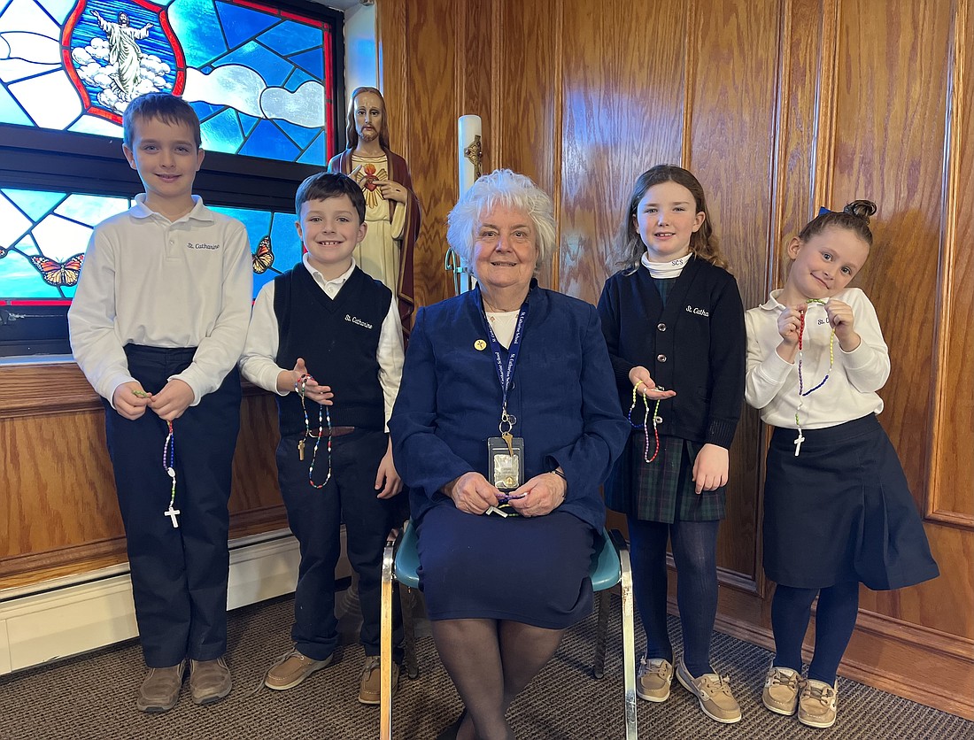 From left, St. Catharine School second graders Julian Rubas, Henry Pepe and Grace Richard and first grader Riley Salkewicz join Sister Carole MacKenthun for Rosary prayer group. Courtesy photo