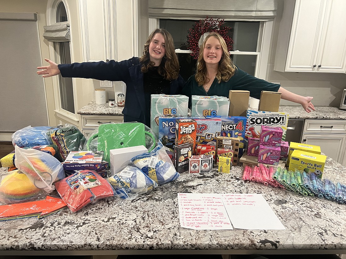 Brooke and Riley Pulaski display some of the donations collected through their nonprofit “For the Love of Recess, Inc.” Courtesy photo