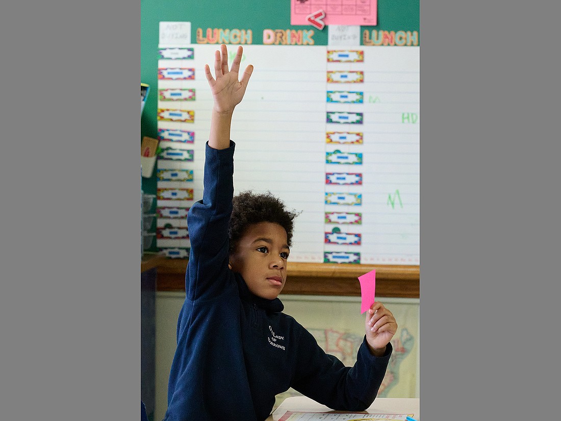 A student from Our Lady of Sorrows School, Hamilton, engages in a Catholic Schools Week conversation during a “Celebrating Vocations” presentation. Mike Ehrmann photo