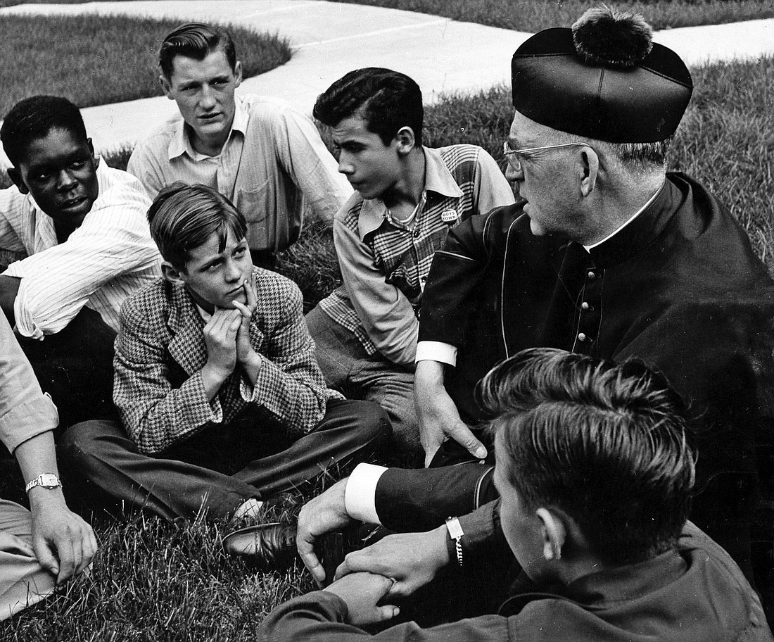 Father Edward Flanagan, the Irish-born priest who founded Boys Town in Nebraska, talks with a group of boys in this undated photo. (OSV News photo/courtesy Boys Town)