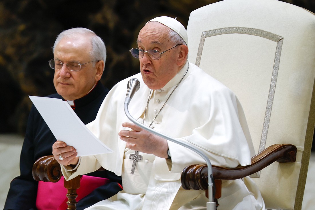 Pope Francis talks to visitors during his weekly general audience in the Paul VI Audience Hall at the Vatican Feb. 14, 2024. Pope Francis continued his general audience talks about vices and virtues, looking at the vice usually called "sloth." (CNS photo/Lola Gomez)