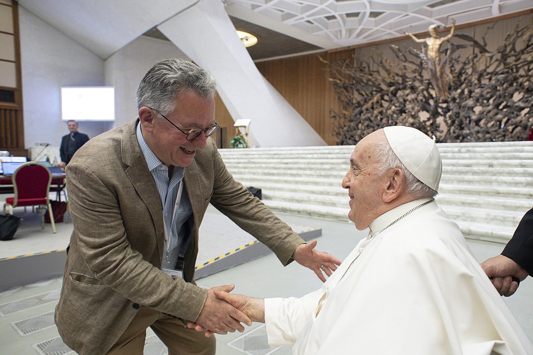 Pope Francis greets Austen Ivereigh, author of "First Belong to God: A Retreat with Pope Francis," during the assembly of the Synod of Bishops in the Vatican's audience hall Oct. 16, 2023. Ivereigh was an expert at the synod. (CNS photo/Vatican Media)