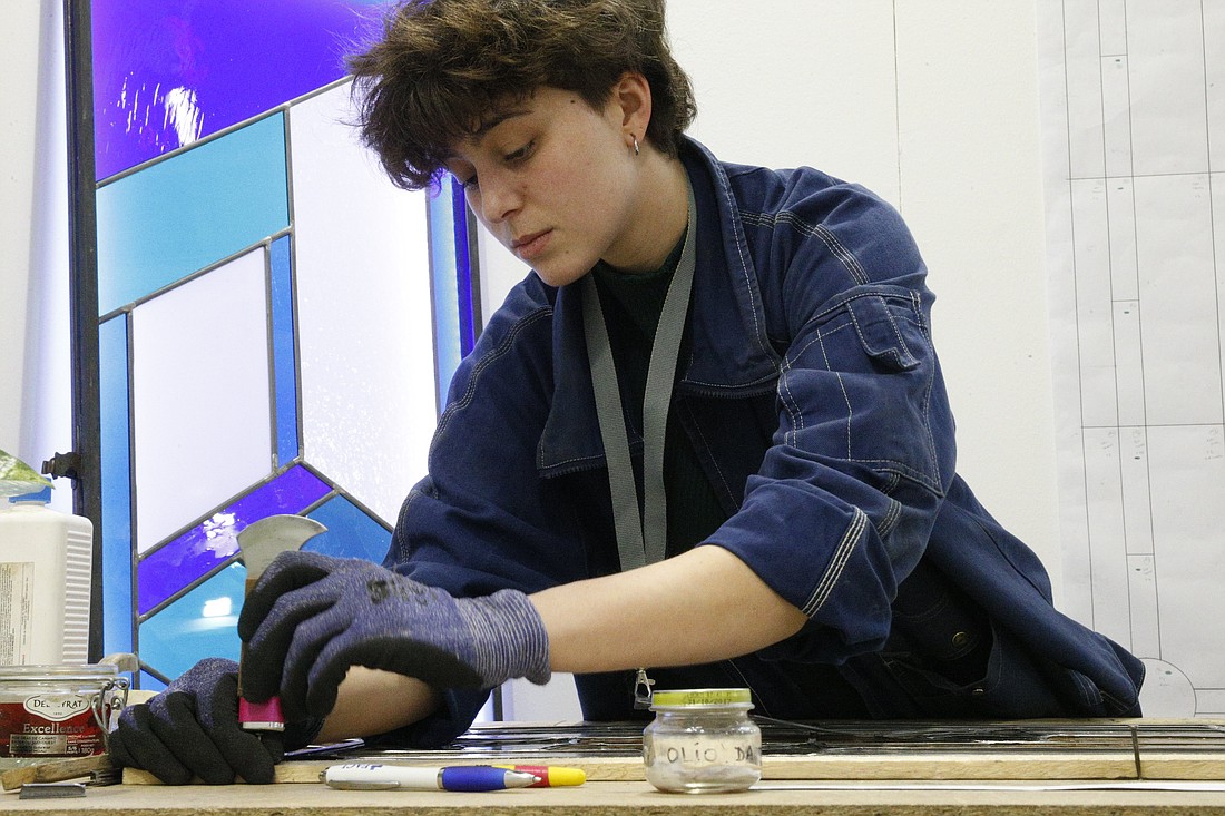 Sofia Malavasi, a stained-glass artist, works on a design at the International Religious Products and Services Exhibition in Bologna, Italy, Feb. 13, 2024. (CNS photo/Justin McLellan)