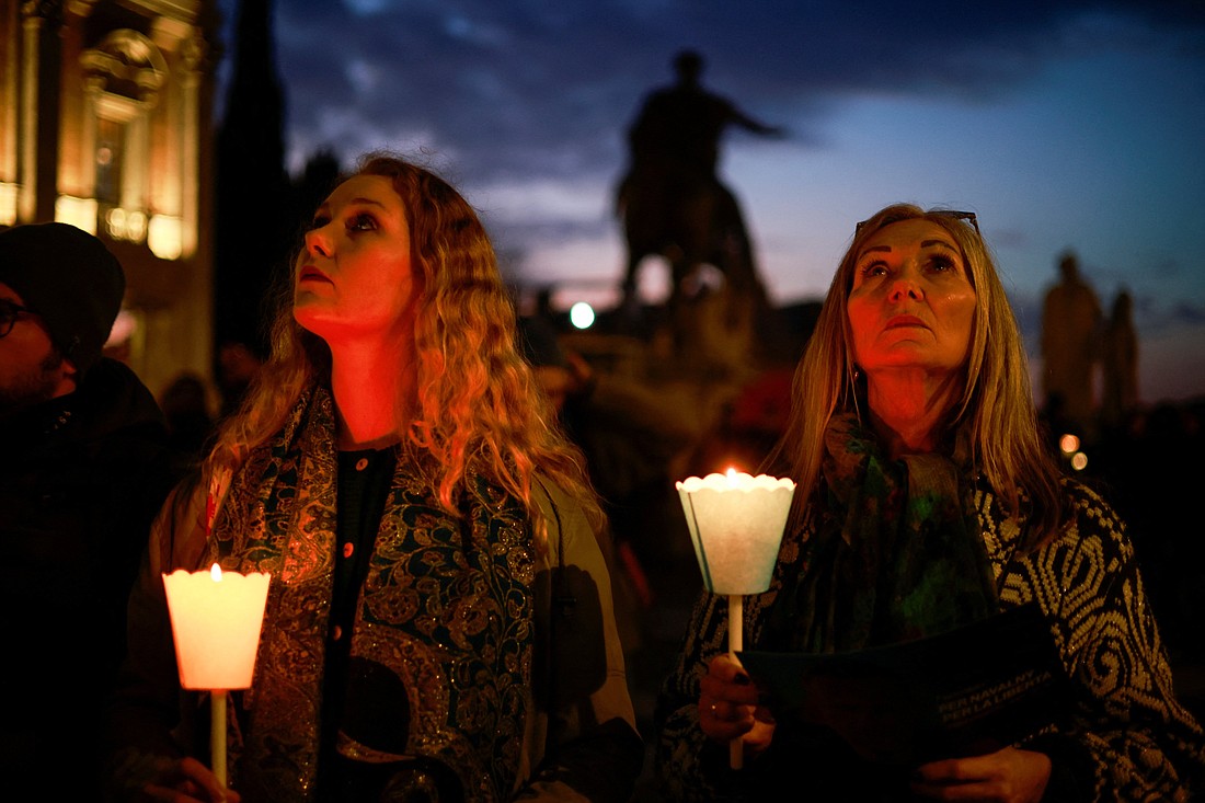 Women hold candles as they attend a vigil in memory of late Russian opposition leader Alexei Navalny at the Campidoglio (Capitoline Hill) in Rome Feb. 19, 2024. (OSV News photo/Yara Nardi, Reuters)