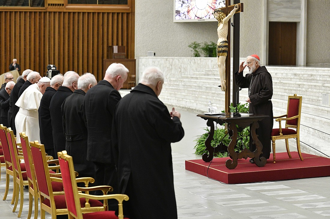 Cardinal Raniero Cantalamessa, preacher of the papal household, makes the sign of the cross before addressing Pope Francis and officials of the Roman Curia during his Lenten reflection in the Vatican audience hall March 24, 2023. (CNS photo/Vatican Media)