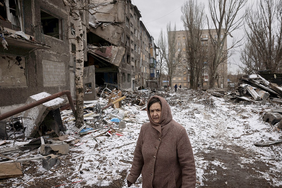 A woman walks past blocks of apartments in Selydove, Ukraine, Feb. 19, 2024, that were destroyed in a Russian airstrike. (OSV News photo/Thomas Peter, Reuters)