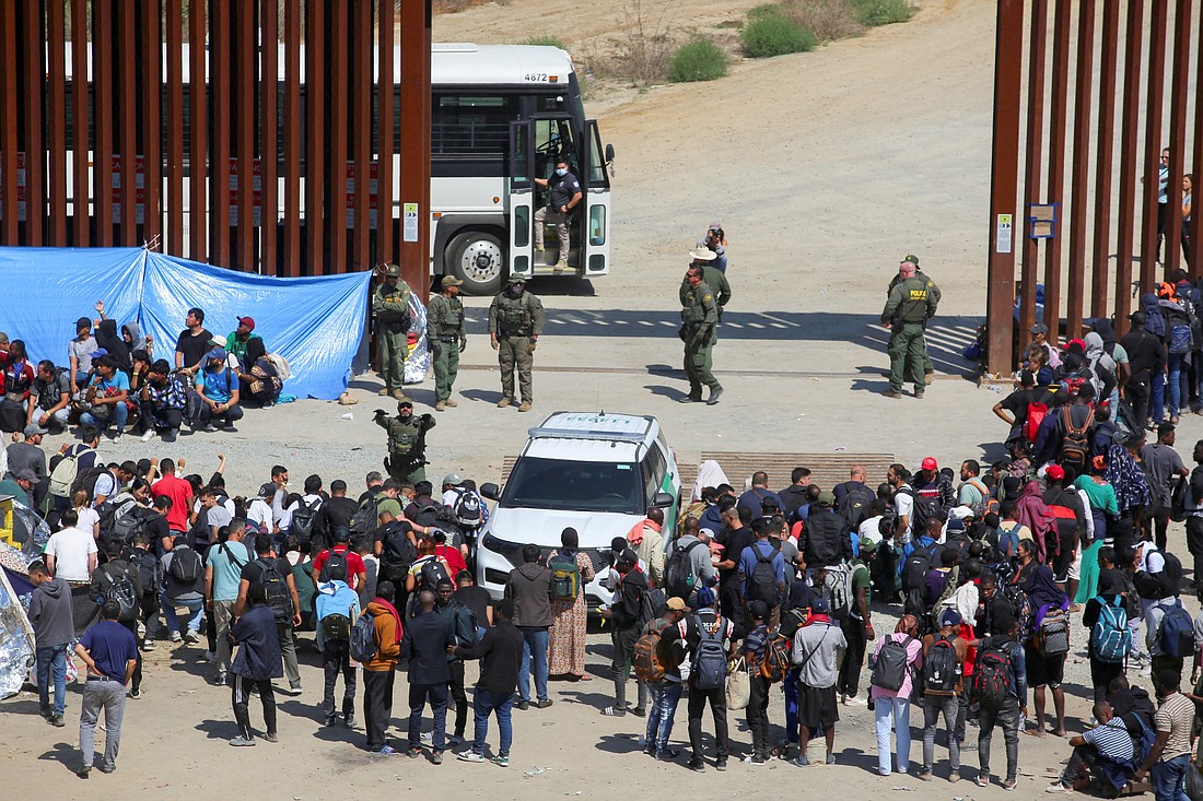 Migrants gather between the primary and secondary fences of the U.S. and Mexico border as they wait to be processed by U.S. Border Patrol agents, as seen from Tijuana, Mexico, Sept. 13, 2023. (OSV News photo/Jorge Duenes, Reuters)