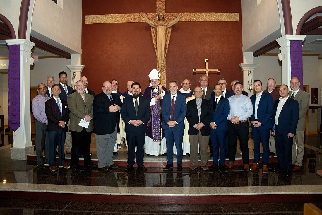 Shown are the Diocese's 19 diaconate candidates who participated in the Rite of Institution of Lectors and the Rite of Institution of Acolytes during a Mass celebrated by Bishop O'Connell in Our Lady of Sorrows Church, Hamilton. Joe Moore photo
