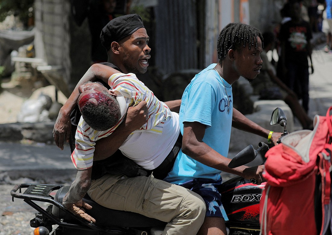 People take a wounded man to a hospital in Port-au-Prince, Haiti, Aug. 15, 2023, after gangs took over their neighborhood Carrefour-Feuilles. (OSV News photo/Ralph Tedy Erol, Reuters) EDITORS: Note graphic content.