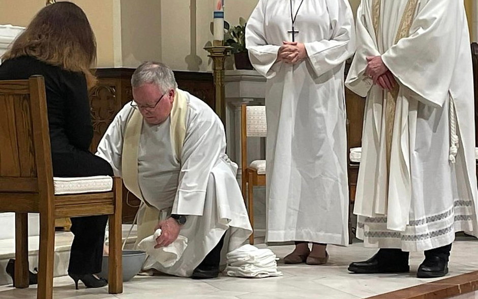 Father James Grogan, pastor, Our Lady of Good Counsel Parish, Moorestown, washes the feet of a parishioner last year on Holy Thursday. Facebook photo.