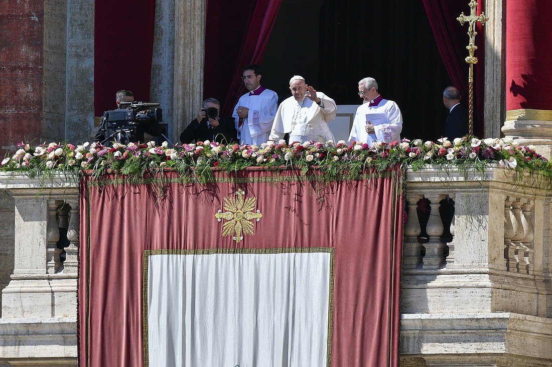 Pope Francis waves to the crowd in St. Peter's Square before he imparts his Easter blessing "urbi et orbi" (to the city and the world) from the central balcony of St. Peter's Basilica April 9, 2023. (CNS photo/Vatican Media)