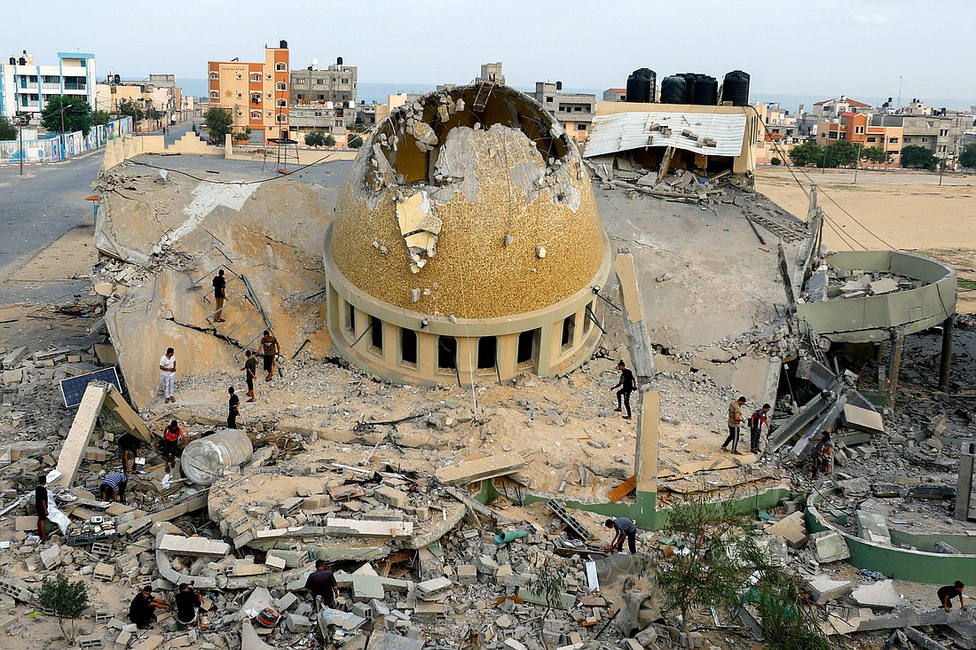 Palestinians inspect a mosque destroyed in Israeli strikes in Khan Younis, in the southern Gaza Strip, Oct. 8, 2023, a day after a brutal attack on Israel by more than 1,300 Hamas terrorists that left more than 1,200 Israelis and other nationals dead. Hamas took more than 200 others, including about 30 children, hostage and brought them back into Gaza. More than 30,000 Gaza Palestinians have been killed since the beginning of the Israel-Hamas war, Gaza's Health Ministry said. (OSV News photo/Ibraheem Abu Mustafa, Reuters)