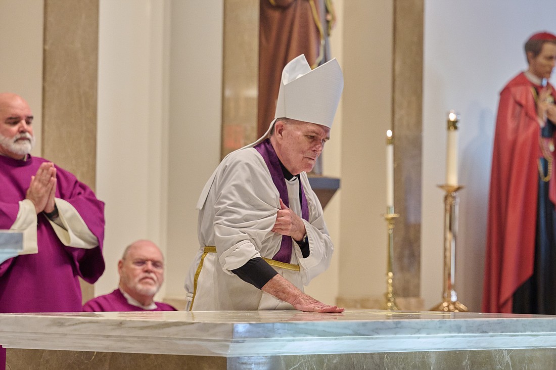 Bishop O'Connell consecrates the altar with Sacred Chrism. Mike Ehrmann photo