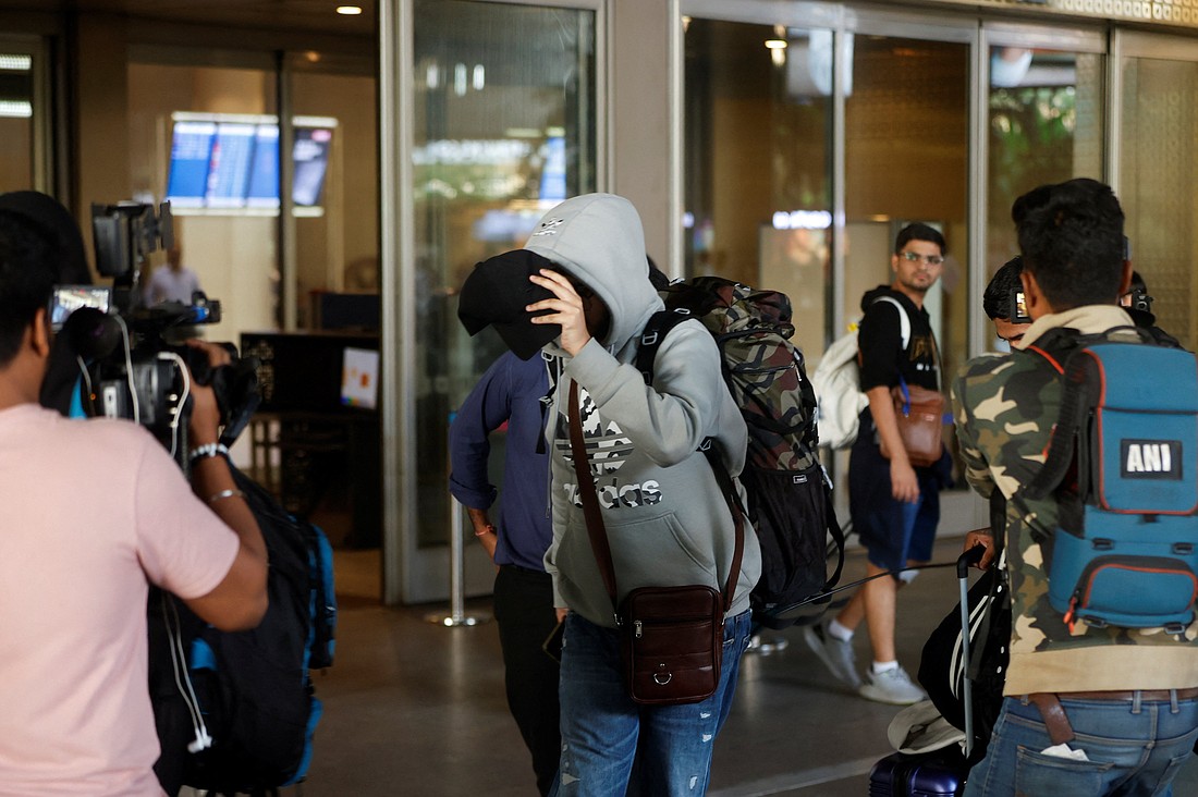 A passenger from a Nicaragua-bound Airbus A340 flight grounded in France on suspicion of human trafficking evades the media as he leaves the Chhatrapati Shivaji Maharaj International Airport after his arrival in Mumbai, India, Dec. 26, 2023. The Georgetown University's Institute on Catholic Thought and Public Life sponsored a March 6, 2024, webinar on human trafficking that included as speakers Catholic sisters working to eradicate this "modern-day slavery" and help trafficking survivors. (OSV News photo/Francis Mascarenhas, Reuters)