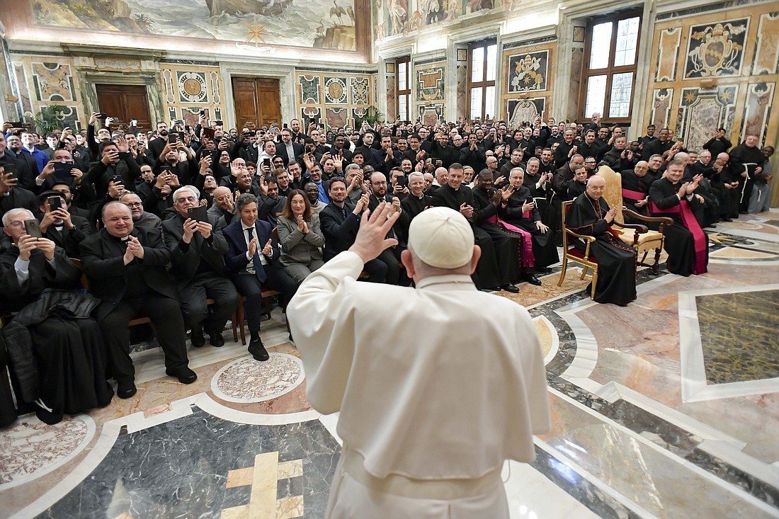 Pope Francis waves to priests who hear confessions in the basilicas of Rome and to priests and seminarians attending a course on confession offered by the Apostolic Penitentiary, the Vatican tribunal that deals with matters of conscience, at the end of a meeting March 8, 2024, in the Vatican's Apostolic Palace. (CNS photo/Vatican Media)