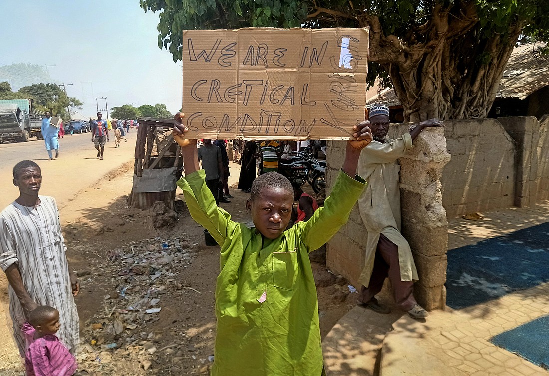 A boy holds a sign in Kaduna, Nigeria, March 8, 2024, protesting current conditions in the country. Recent kidnappings of hundreds of people, including almost 300 schoolchildren March 7 in Kuriga in the central part of Nigeria, have left church leaders and parents, including Catholics, speechless as kidnappings become a horrific new normal. (OSV News photo/Reuters).